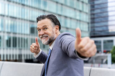Happy mature businessman showing thumbs up - OIPF02712