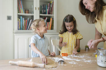 Happy woman with girls preparing cookies at home - SVKF00764