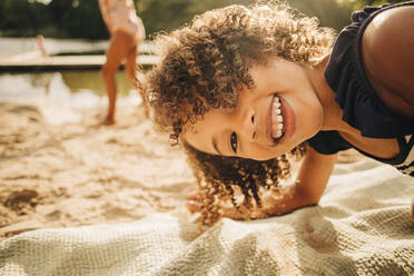 Portrait of playful girl with curly hair enjoying on vacation - MASF32643