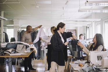 Fashion designers working together at workshop - MASF32721
