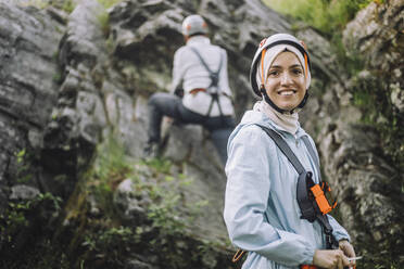 Porträt einer lächelnden Frau mit Helm beim Klettern - MASF33268