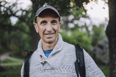 Portrait of smiling mature man hiking in forest - MASF33285