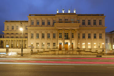 Germany, Berlin, Vehicle light trails in front of Kronprinzenpalais at dusk - WIF04643