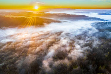 Germany, Baden-Wurttemberg, Drone view of Haselbachtal valley at foggy autumn sunrise - STSF03673
