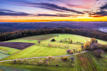 Germany, Baden-Wurttemberg, Drone view of countryside fields in Swabian-Franconian Forest at autumn sunrise - STSF03679