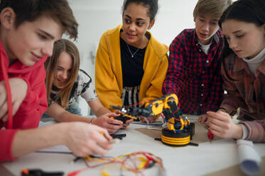 A group of students building and programming electric toys and robots at robotics classroom - HPIF00056