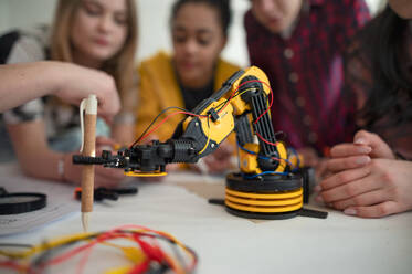 A group of students building and programming electric toys and robots at robotics classroom - HPIF00057