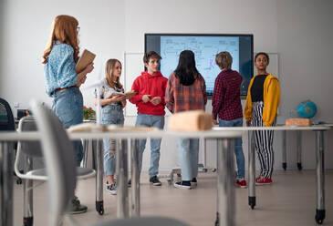 A college student explaining some ideas on a touch TV in classroom. - HPIF00079