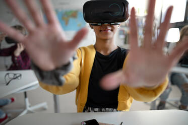 Close-up of a student wearing virtual reality goggles at school in computer science class. - HPIF00094