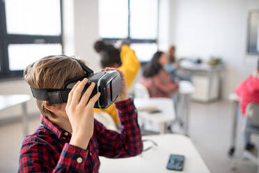 Neugierige Schülerin trägt eine Virtual-Reality-Brille im Informatikunterricht in der Schule - HPIF00166