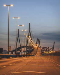Germany, Hamburg, Illuminated Kohlbrand Bridge at dusk - KEBF02491