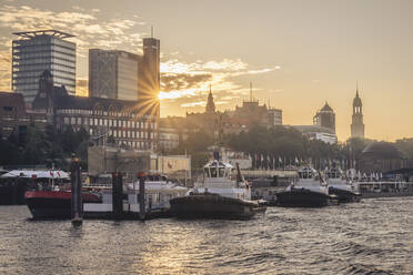 Germany, Hamburg, Boats moored in St. Pauli piers at sunset - KEBF02493