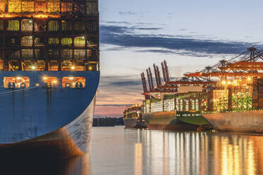 Germany, Hamburg, Container ships in Port of Hamburg at dusk - KEBF02518