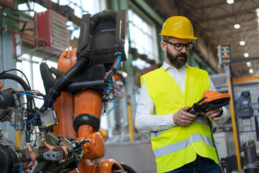 An automation engineer holding scanner in industrial in factory. - HPIF00722