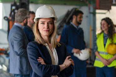 A portrait of female chief engineer in modern industrial factory looking at camera. - HPIF00732