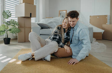 A cheerful young couple in their new apartment. Conception of moving. - HPIF00815