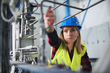 Porträt einer Ingenieurin bei der Arbeit in einer Industriefabrik - HPIF00894