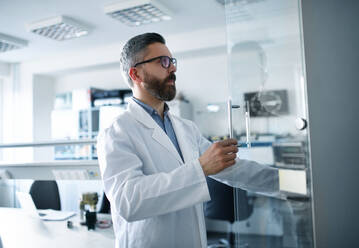 A robotics engineer working on desing of modern robotic arm in laboratory. - HPIF00932