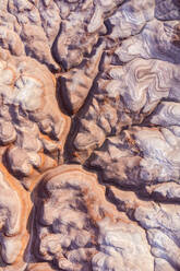 Aerial view of abstract background of colorful rough surface of rocky formations in Long Dong Silver on sunny day in Utah - ADSF41036
