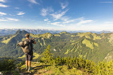 Germany, Bavaria, Male hiker admiring surrounding landscape from summit of Hirschberg mountain - FOF13218