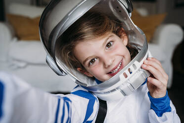 Happy girl wearing space costume taking selfie at home - EBBF07366