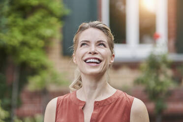 Happy woman daydreaming in back yard - RORF03130