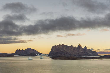 Panoramic aerial view of the beautiful bay with mountain and ice formation at sunset, Sermersooq, Greenland. - AAEF17066