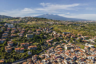 Aerial view of Aci Trezza with Etna Volcano in background, Sicily, Italy. - AAEF17090