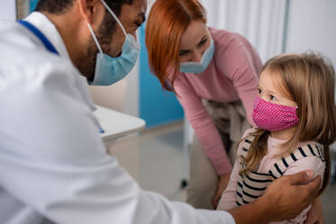 A little girl with her mother at doctor's office on consultation, coronavirus concept. - HPIF01143