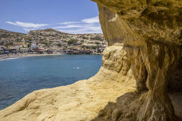 Greece, Crete, Matala, Coastal village seen from cliffside cave - MAMF02327