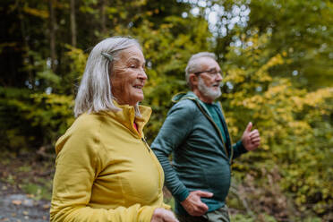 Happy senior couple hiking in autumn nature. - HPIF01310