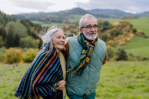 Happy senior couple walking in autumn nature. - HPIF01344