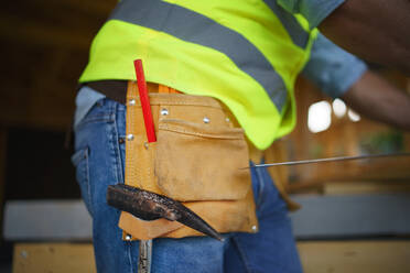 Close-up of unrecognizable construction worker in protective clothes and his working tools. - HPIF01607