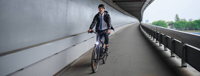 Geschäftsmann Pendler auf dem Weg zur Arbeit, mit dem Fahrrad über die Brücke, nachhaltiger Lebensstil Konzept. - HPIF01817