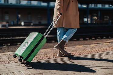 A woman traveler tourist waiting with luggage at train station, cut out. - HPIF02271