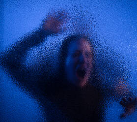 The shadow of woman screaming behind the glass, domestic violence concept. - HPIF02726