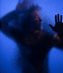 The shadow of woman screaming behind the glass, domestic violence concept. - HPIF02731