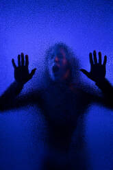 The shadow of woman screaming behind the glass, domestic violence concept. - HPIF02732