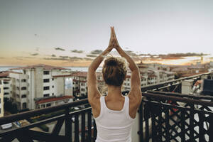 Serene woman enjoying the sunset on roof terrace - SIF00646