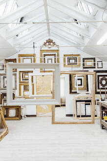 Different designs and patterns of frames hanging in studio - MEUF08820