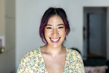 Cheerful young woman with dyed hair at home - WPEF06829