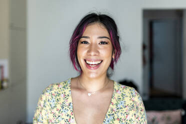 Happy young woman with dyed hair at home - WPEF06830