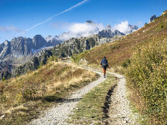Active senior man hiking on sunny day at Vanoise national park, France - LAF02784