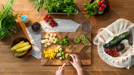 A top view of unrecognizable woman preparing fruit and vegetables, sustainable lifestyle. - HPIF03079