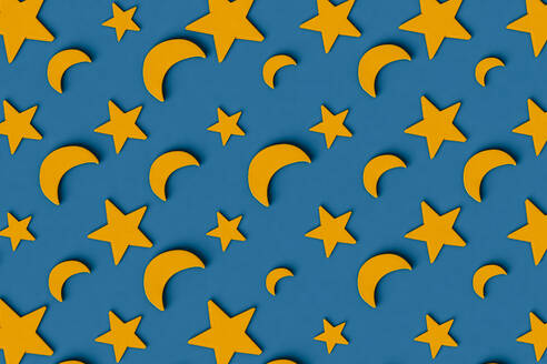 Three dimensional pattern of rows of yellow stars and crescent moons flat laid against blue background - GCAF00223