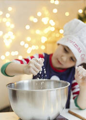 Boy preparing gingerbread in kitchen - ONAF00293