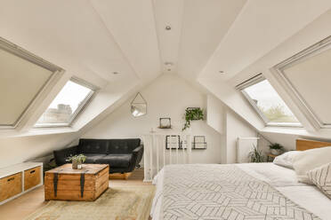 Comfortable bed next to a bright window and wooden floor - ADSF41569