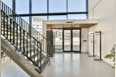 Stairs in a light modern entrance building with big windows - ADSF41636