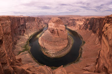 Picturesque view of Horseshoe Bend formation of Grand Canyon with curvy river located against cloudy evening sky in Arizona, USA - ADSF41775