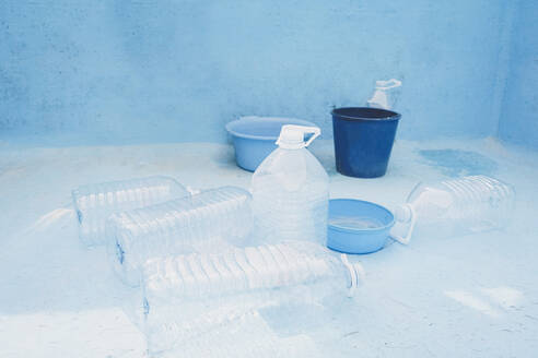 Plastic bottles and bucket in empty pool - SVCF00227